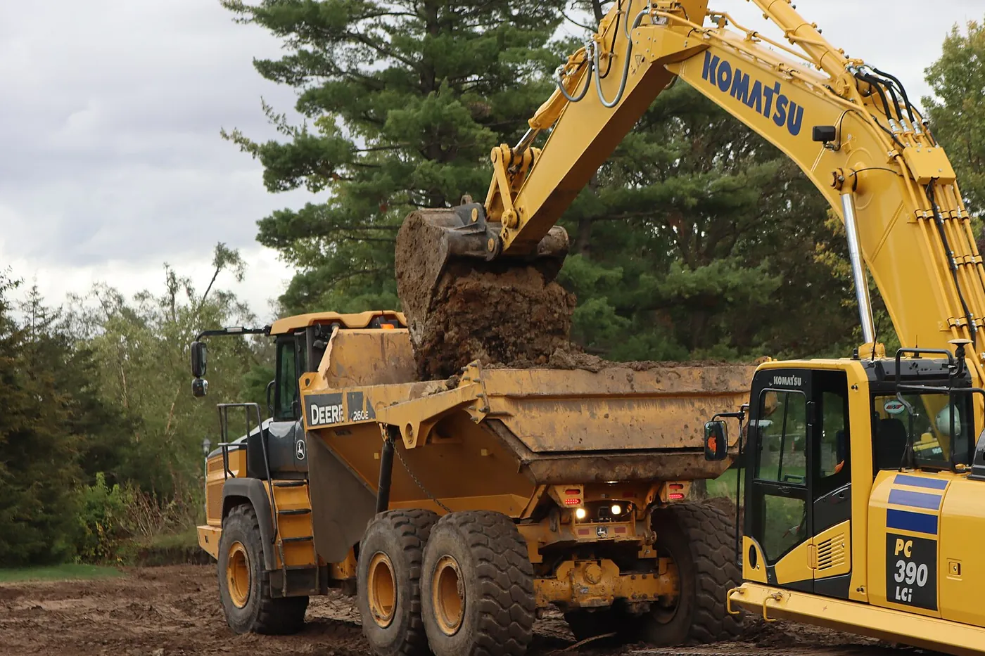 Excavator loading dirt into a dump truck
